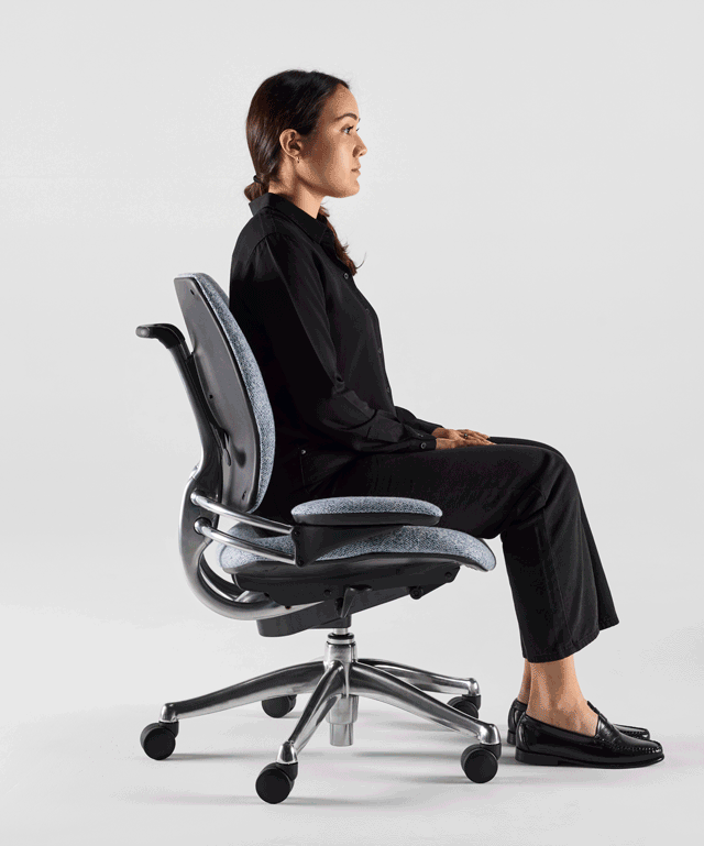 Close-up of a person maintaining correct ergonomic posture in a high-performance office chair.