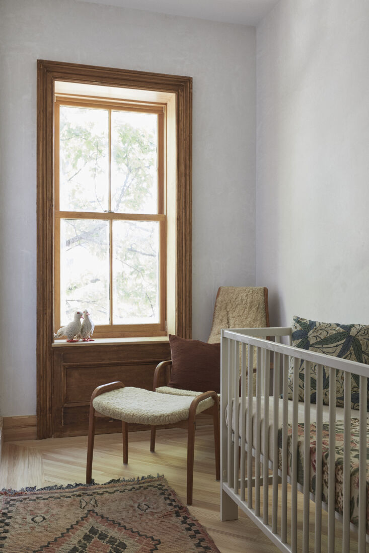 A minimalist nursery room with hand-troweled plaster walls and a luminous finish.