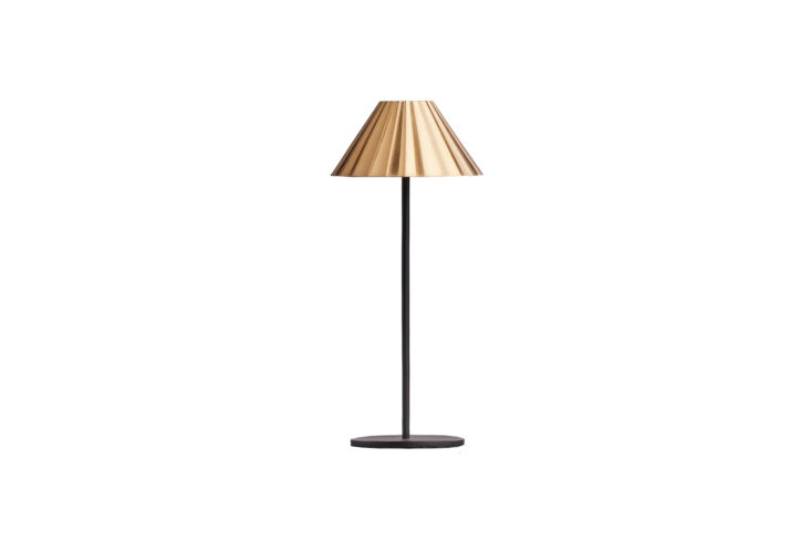 The Pooky Twinky Cordless Table Lamp with a black base and antiqued brass hood.