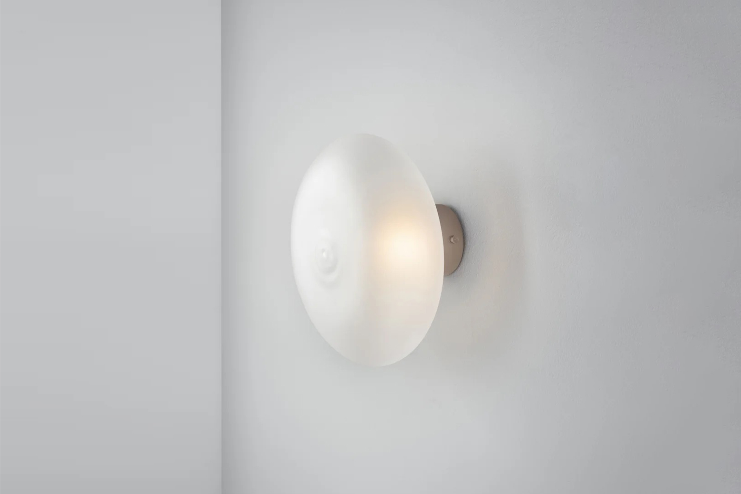 An organic-shaped Halo Sconce in frosted tinted glass by Sal.