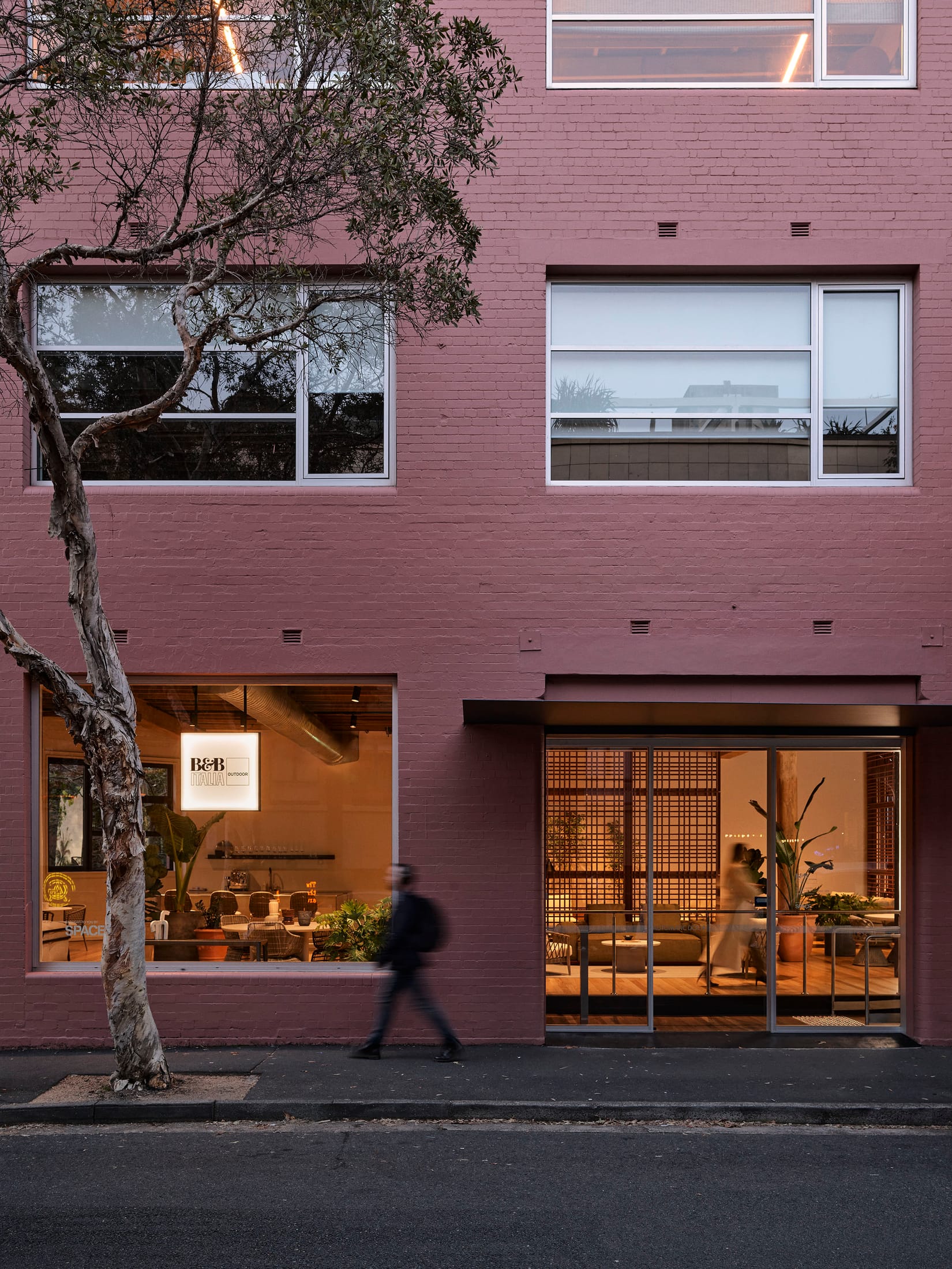 Modern outdoor setting featuring sage green tones and sculptural furniture pieces.