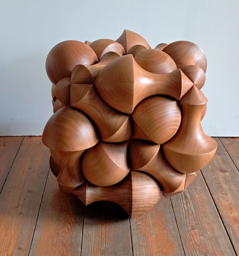Detailed view of the bulbous, rounded shapes of the cherry wood storage box.