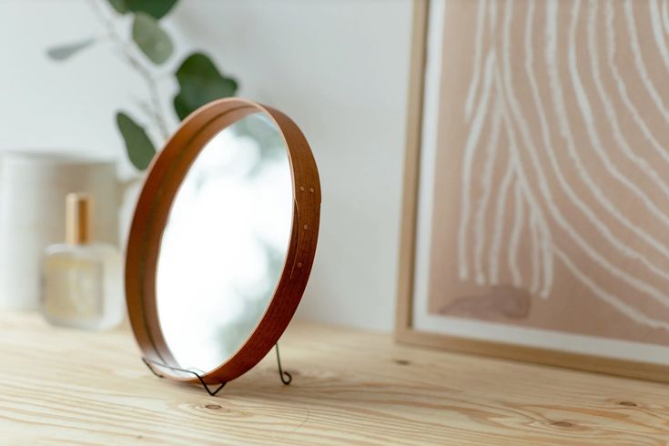 Round and oval Shaker-style mirrors with bentwood frames.