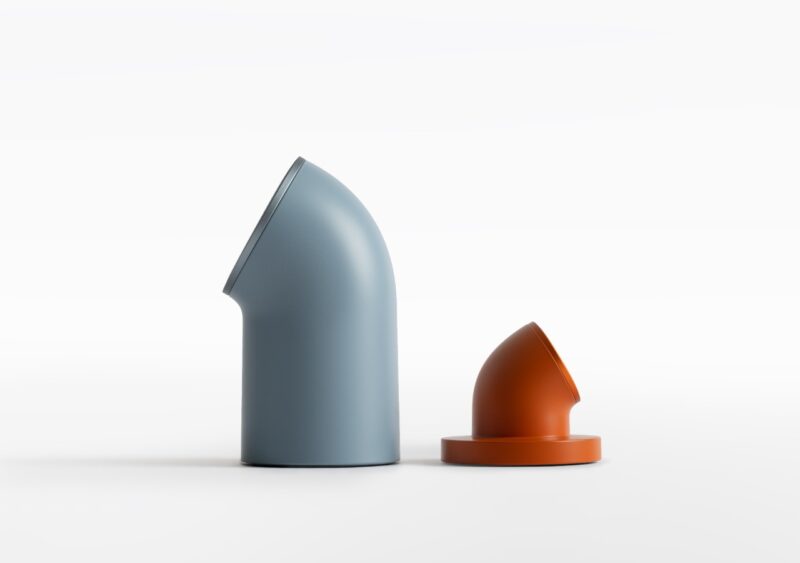 Two minimalist, rounded charging modules in blue-gray and orange standing against a clean white background.