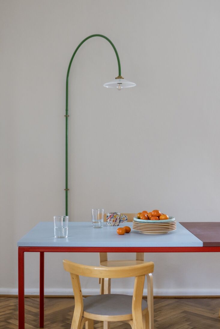 A Muller Van Severen Hanging Lamp No. 2 arching over the dining area.