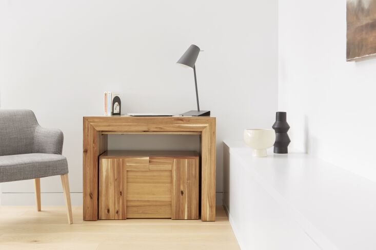 An 18-inch Transformer Table console made of Australian acacia wood used as a side table.