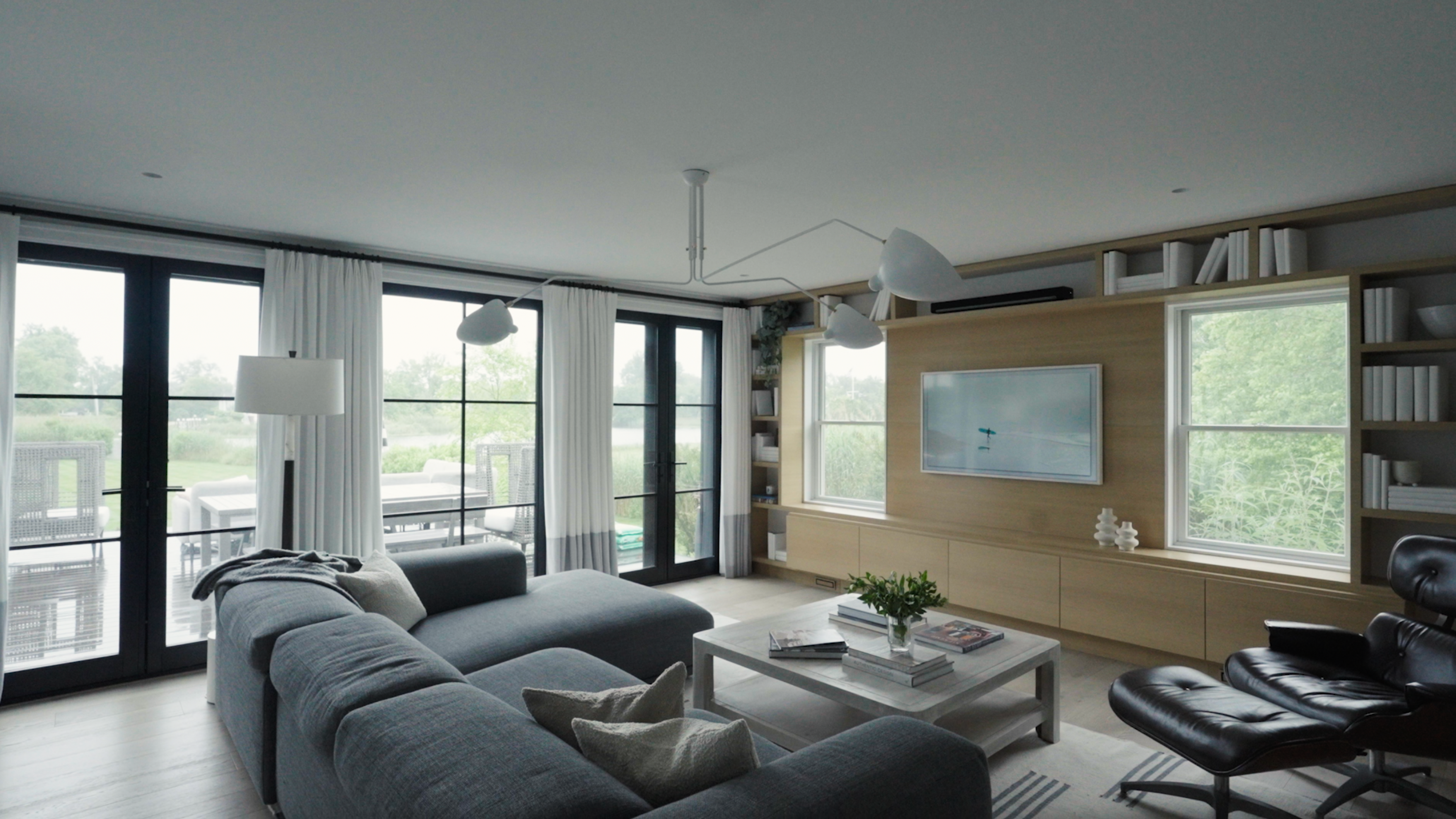 A sun-drenched living room with expansive views and modern furniture.