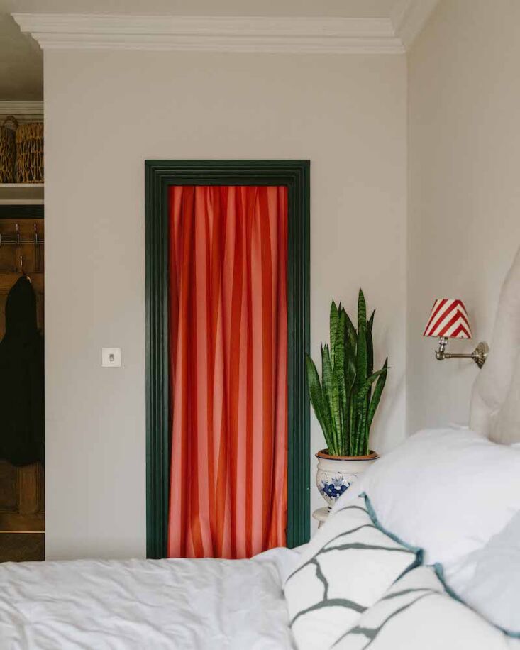 Pink and white midi-striped curtains hanging in a brightly lit room.