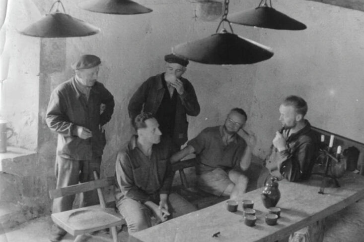 Black and white archival photo of artisans working in a wood workshop.