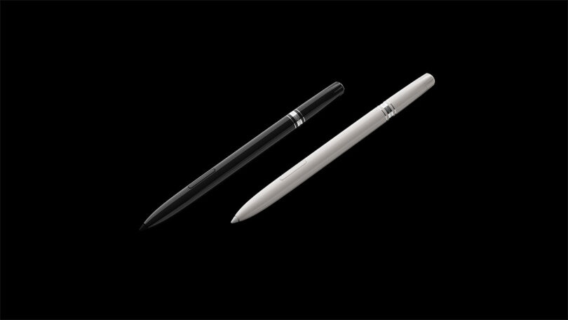 A black pen and a white pen placed diagonally side by side on a dark background.