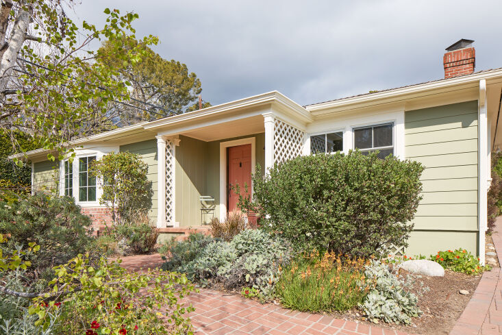 Exterior view of the 1,730-square-foot Altadena house among trees.