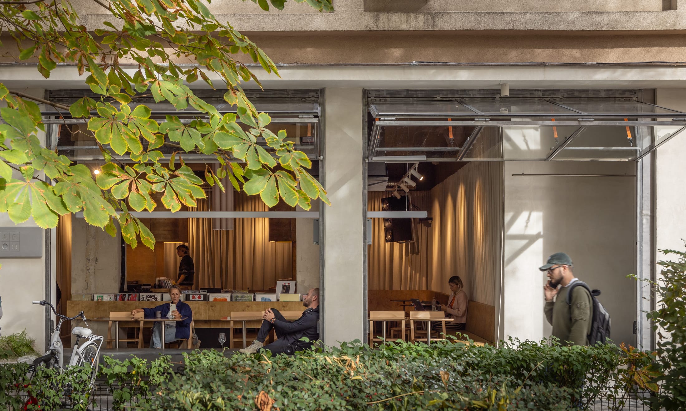 A wide-angle interior shot of Bar Ton showing the bar counter and the 'room within a room' timber structure.