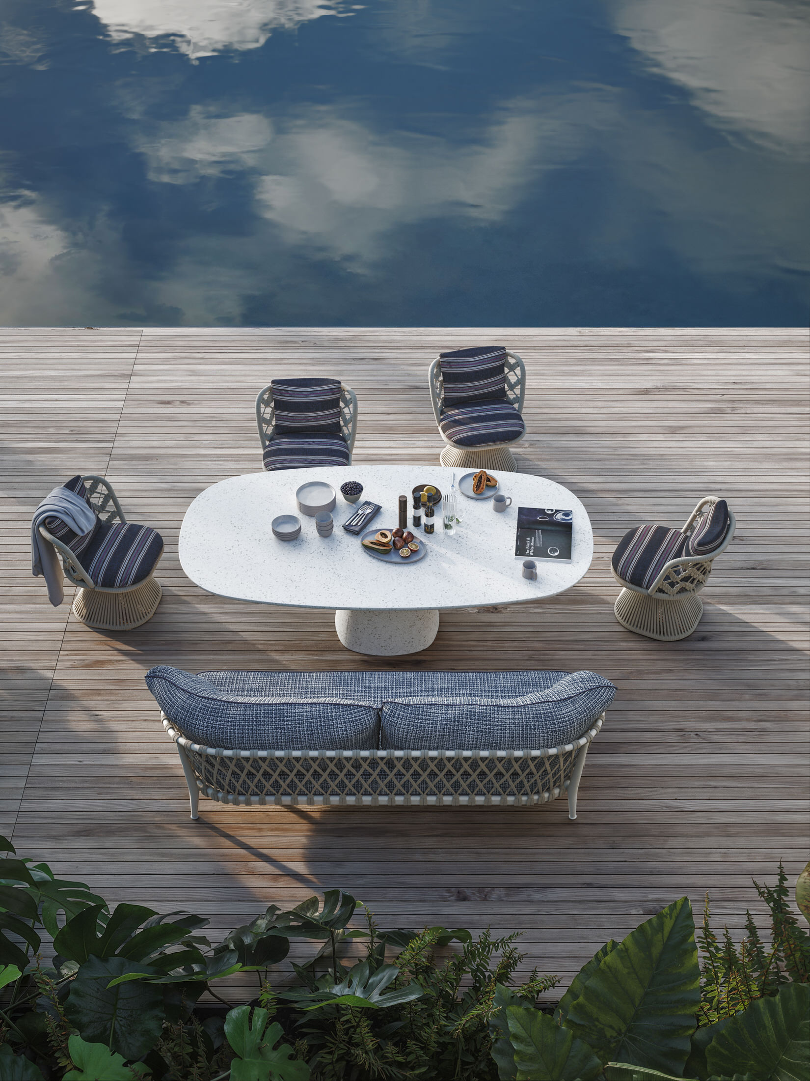 An outdoor dining setup featuring a modern table and woven dining chairs.