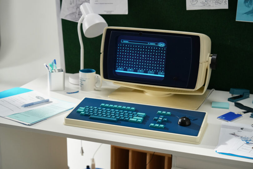 A vintage CRT monitor and the MDR Dasher keyboard in a dimly lit office setting resembling the Severance set.