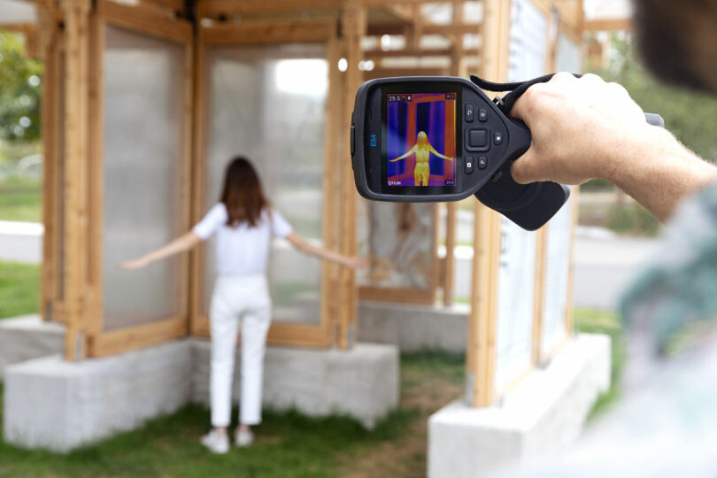 A thermal camera view showing the heat signature of a person inside the cooling structure.
