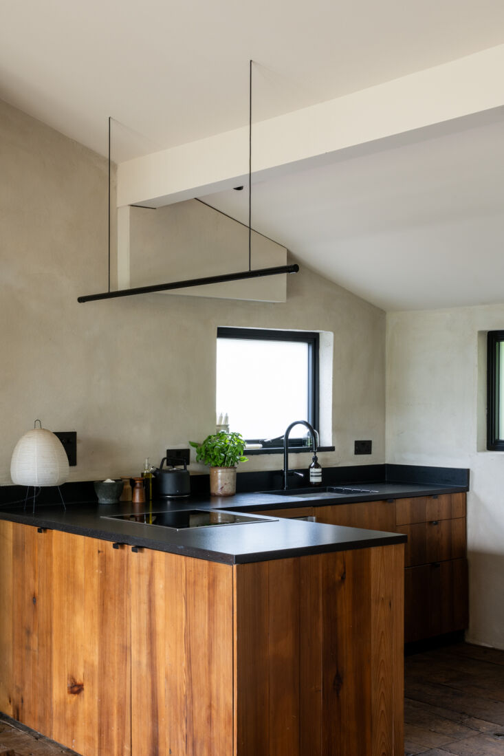 Handcrafted kitchen cabinets made from salvaged cedar timber cladding.