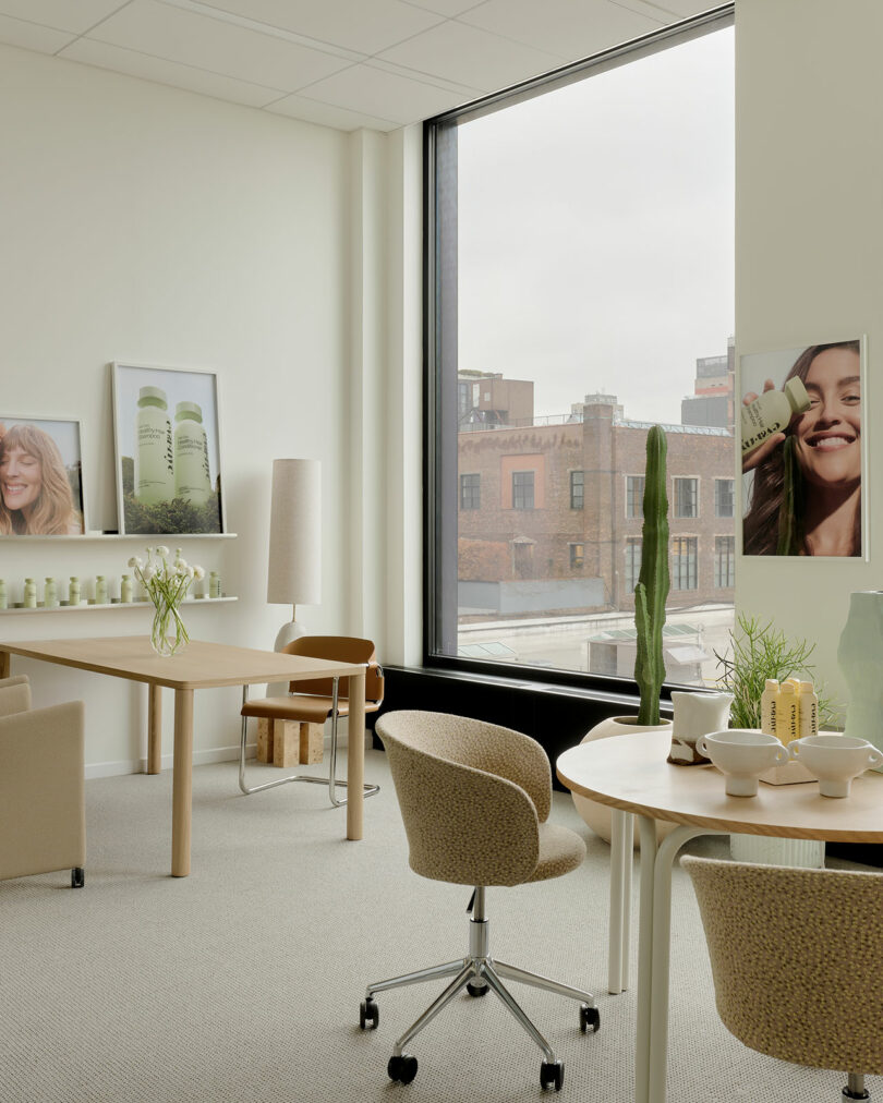 Modern office interior with product displays on shelves and large posters featuring Amika's hair care branding.