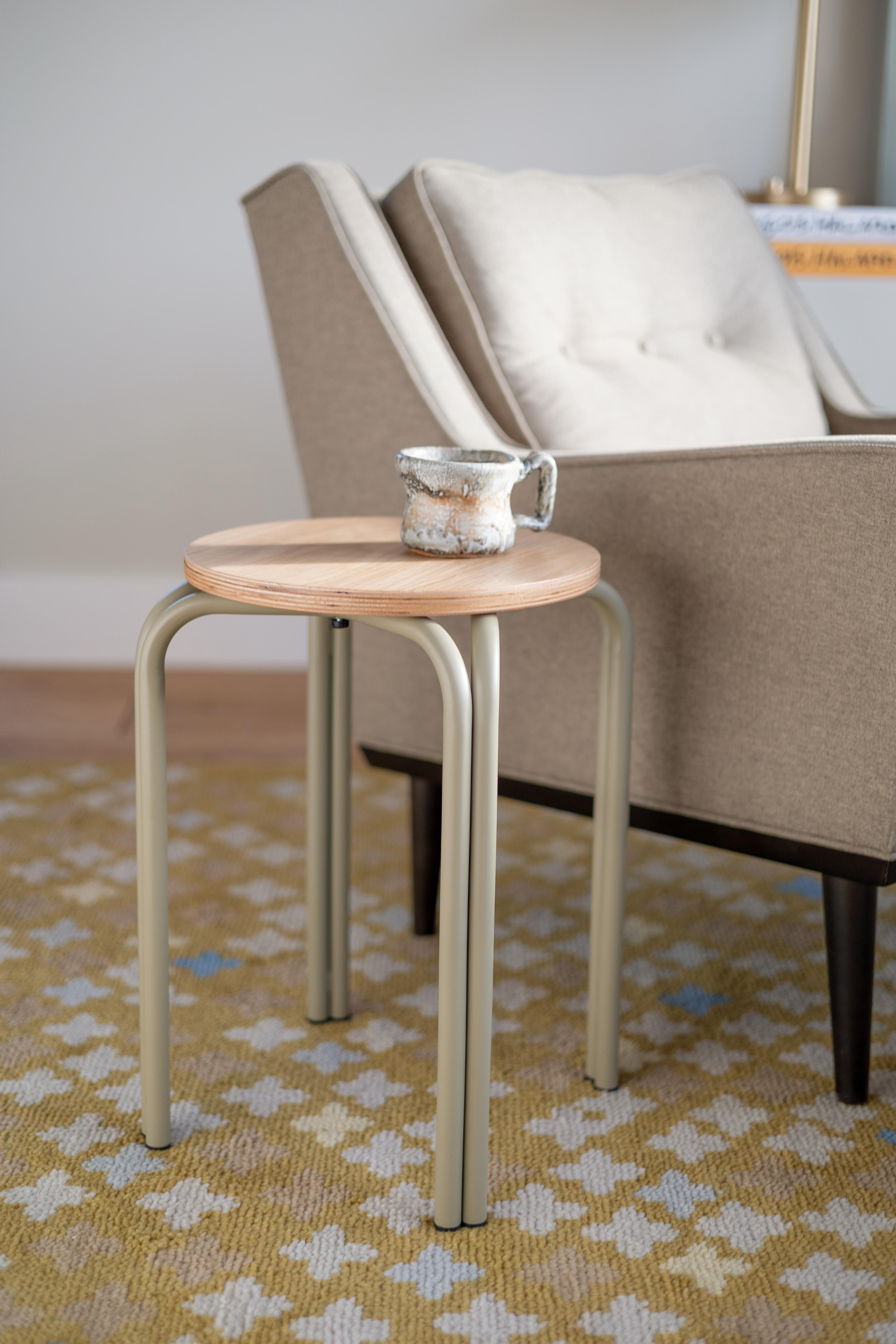 A minimalist side table placed on a textured rug to create a cozy home office atmosphere.