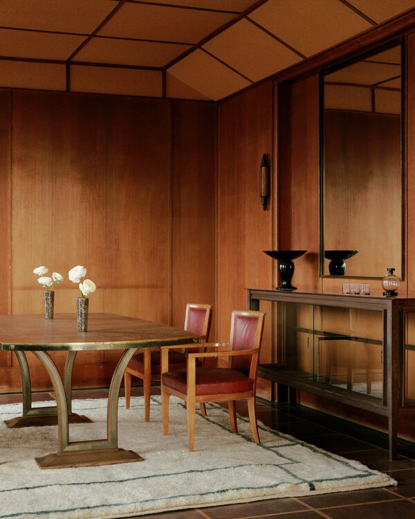 A room filled with indoor plants, natural wood furniture, and organic linen textiles.