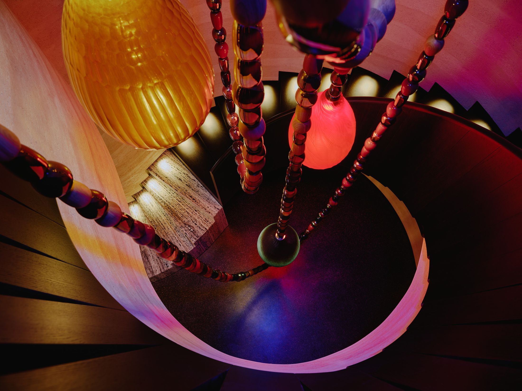 Overhead view of circular pendant lighting constellations in the nightclub.