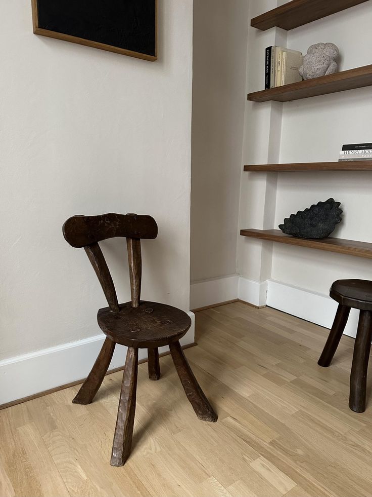 A thick, sculptural 1960s Brutalist wooden chair with heavy legs and a robust frame.
