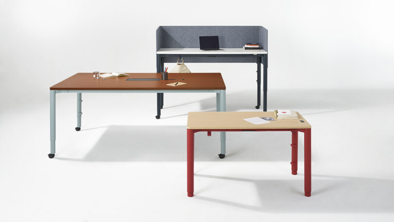 A lineup of three Spout desks in different sizes and color configurations including gray, brown, and beige.