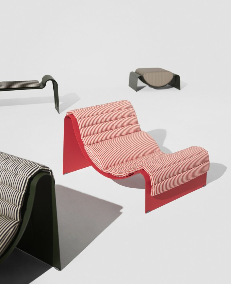 Four modern lounge chairs with wavy designs and patterned fabric upholstery arranged on a white background.