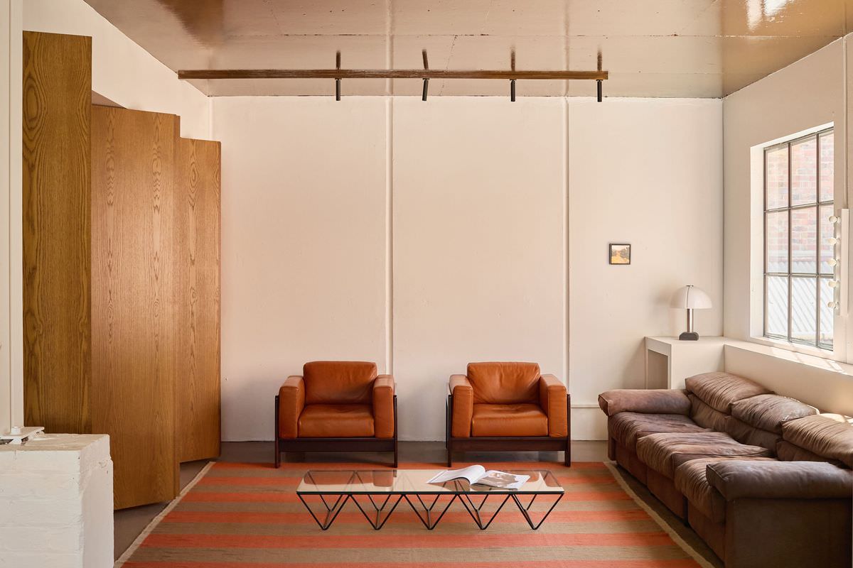 A cozy lounge corner with earthy tones, a plush sofa, and curated decor.