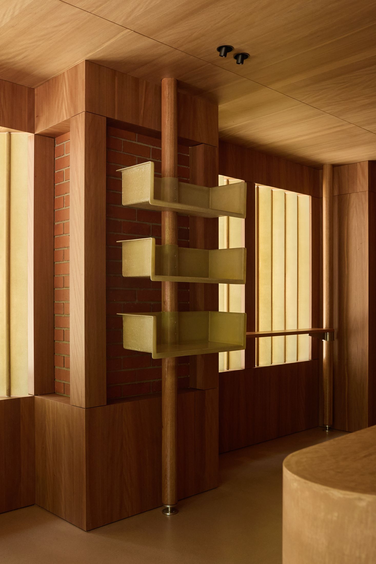 Close-up detail of Victorian ash joinery and smooth timber surfaces in a cafe interior.
