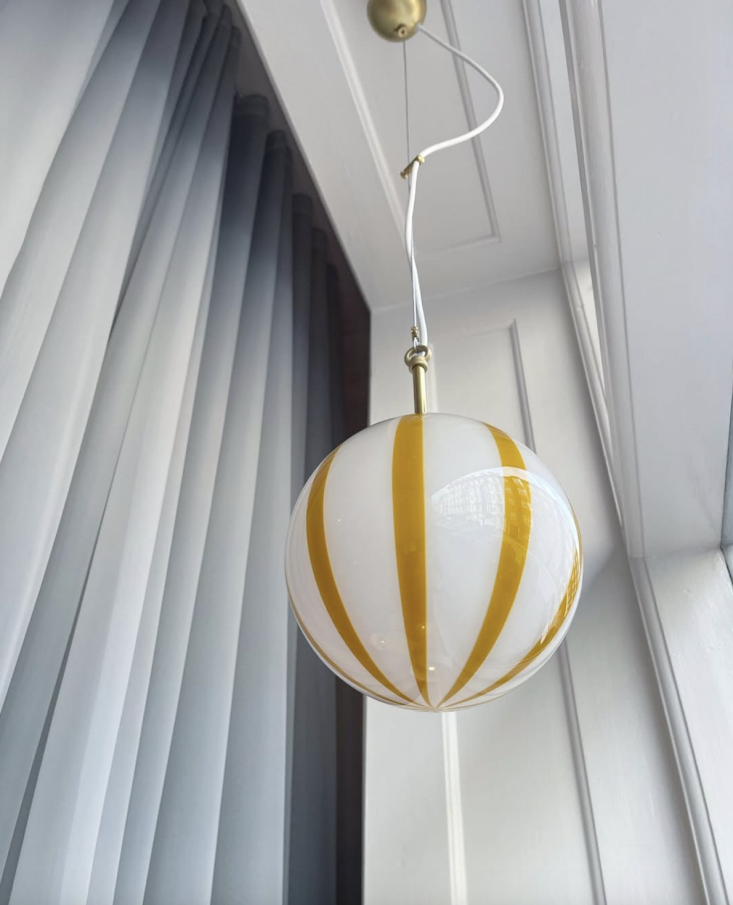 An amber and white striped handblown glass pendant lamp.