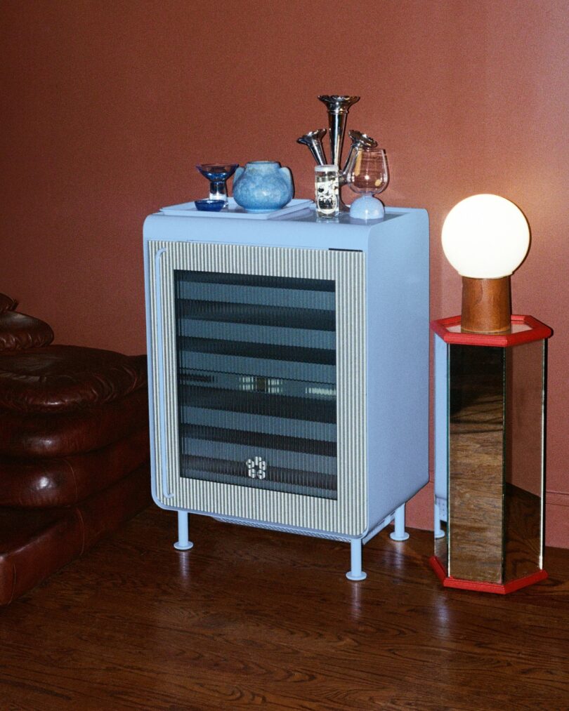 A minimalist cabinet setup with glass shelves and decorative lighting in a modern interior.