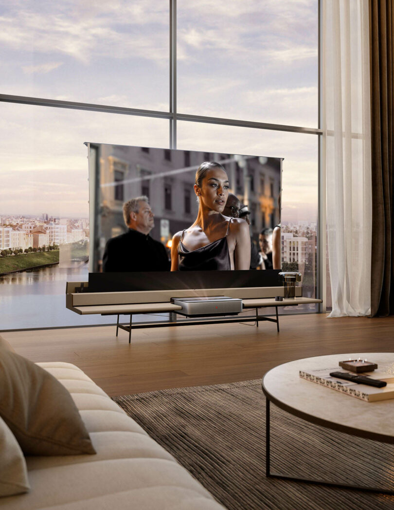 A large projector screen displaying a high-definition movie scene in a modern living room with city views.