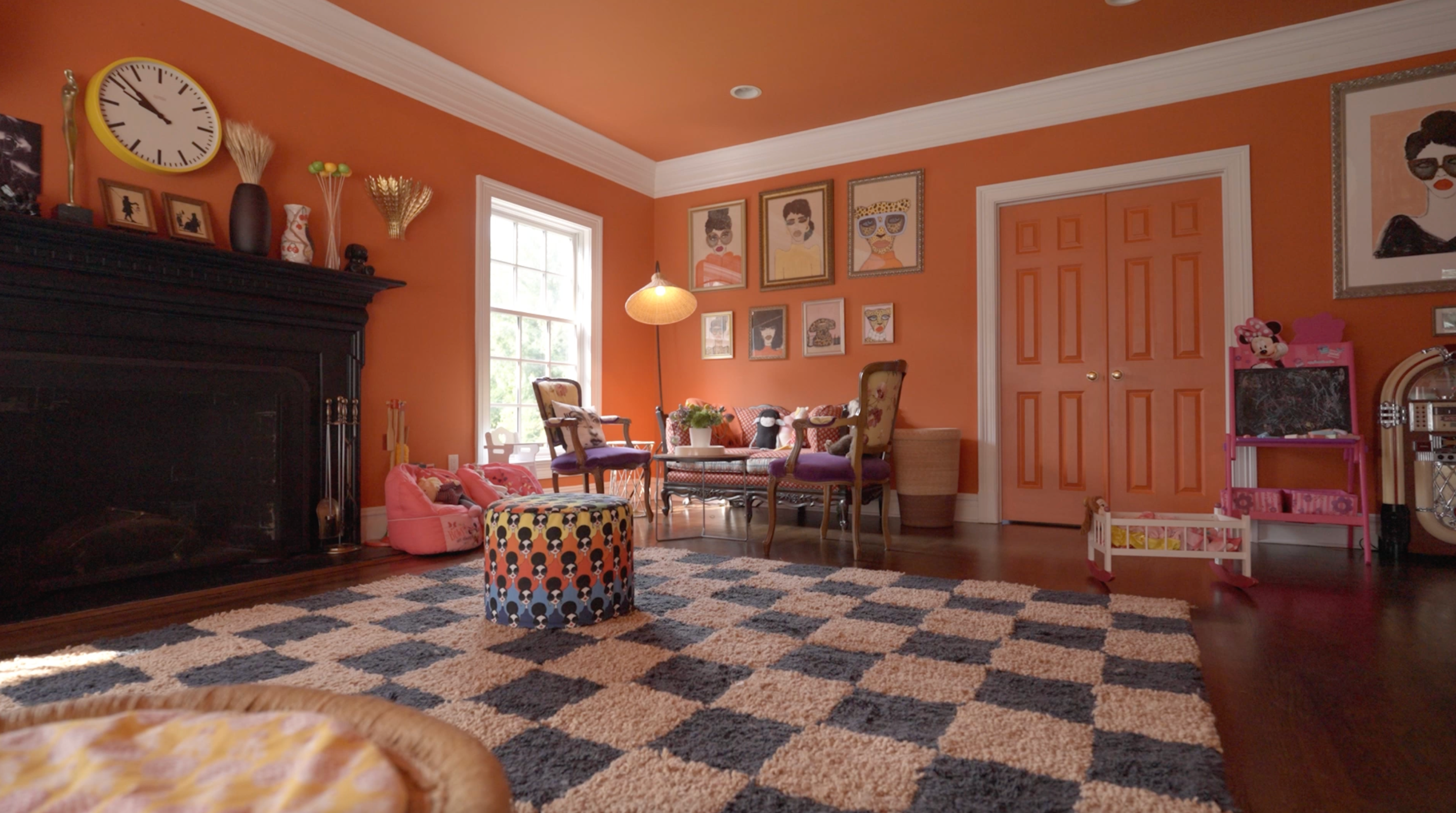 Spacious living room with a large patterned rug and coordinated supporting textile layers.