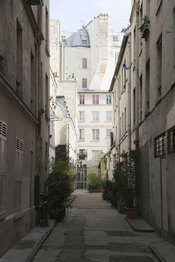 The exterior courtyard of a traditional 19th-century Parisian apartment block where the warehouse is located.