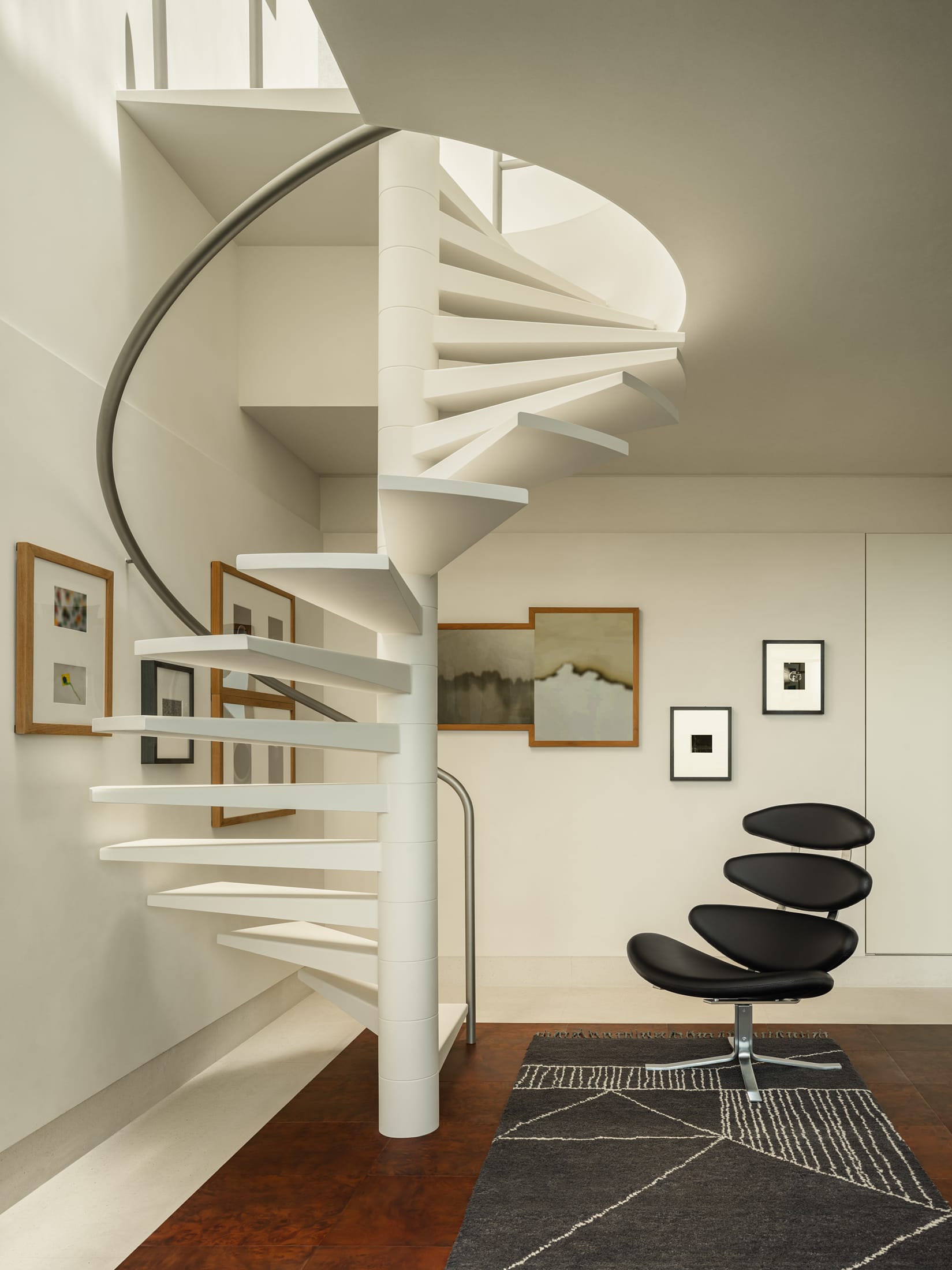 A luxury kitchen and dining area opening directly onto an internal glass-walled courtyard.