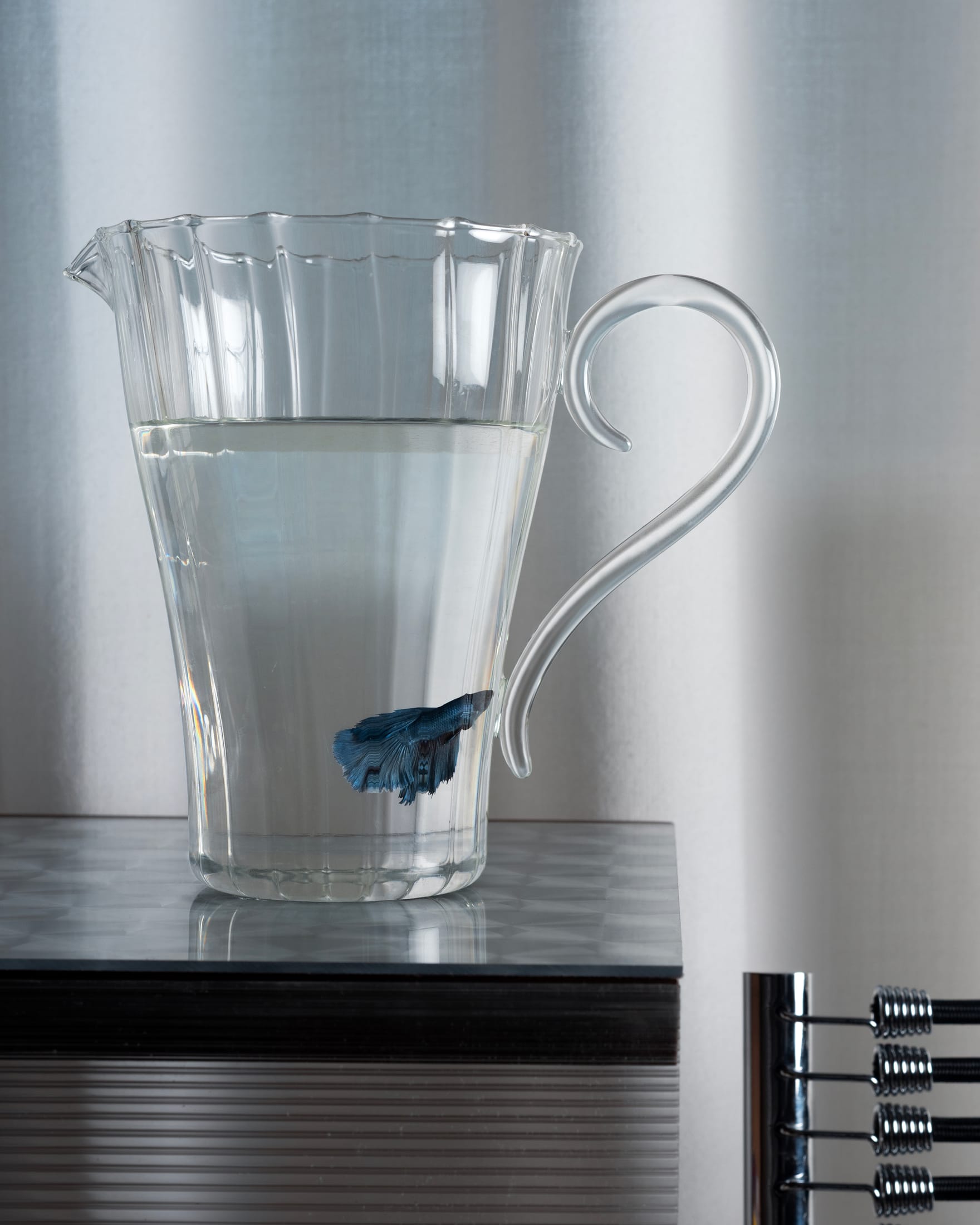 An ensemble of Sophie Lou Jacobsen glassware including pitchers and bowls in various colors.