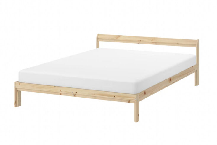 A simple pine wood IKEA Neiden bed frame showing its basic structural design.