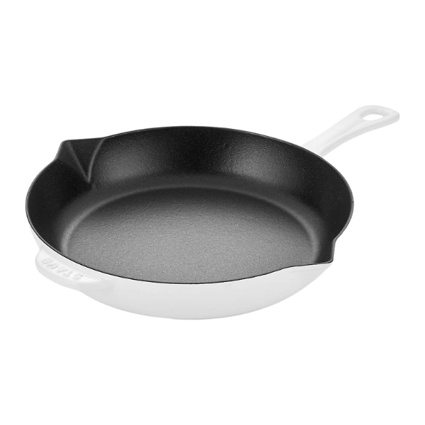 The cast iron skillet being placed into a hot oven to finish the chicken.