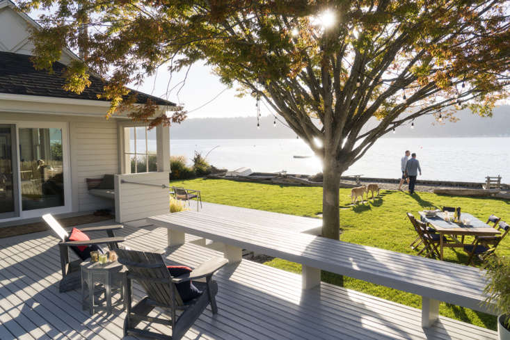 A multi-tiered wooden deck overlooking the water of Puget Sound.
