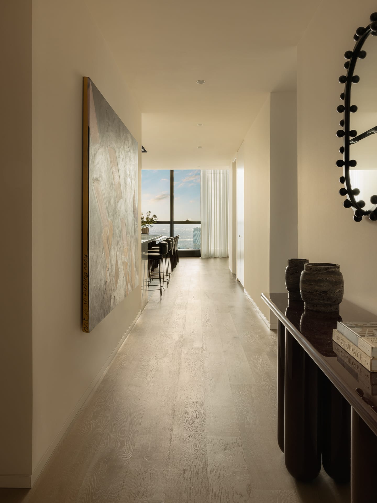 A high-end designer kitchen featuring dark wood cabinetry and integrated appliances.