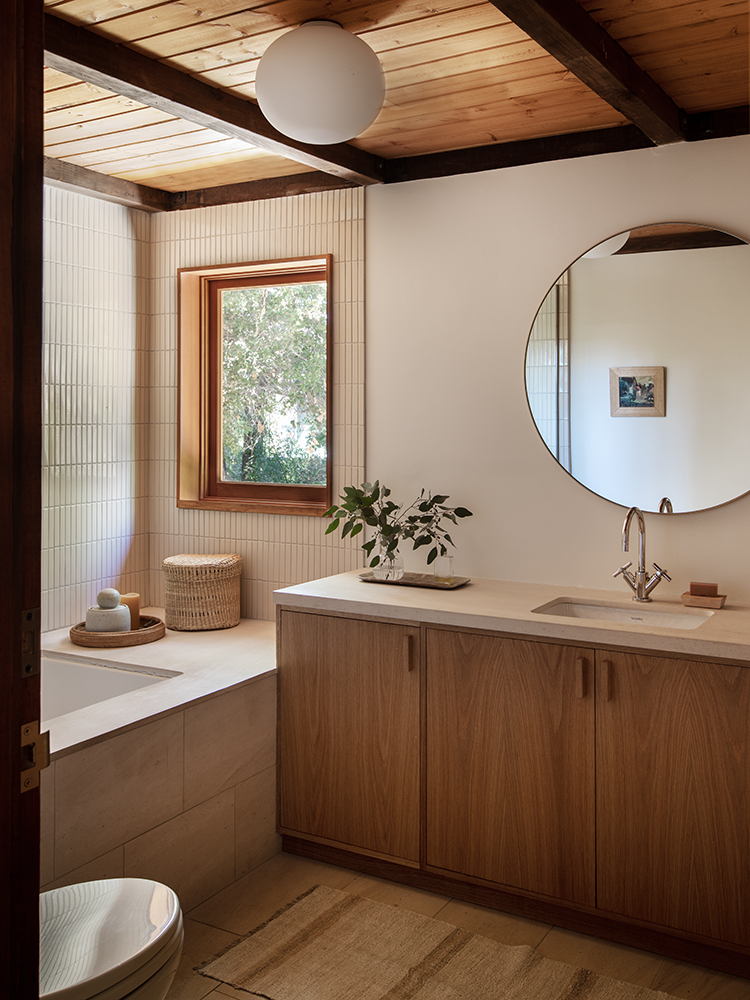Detail of custom wood millwork on a bathroom vanity console with clean lines.