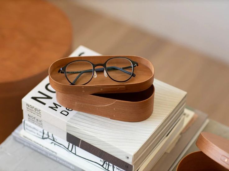 A small, rectangular cherry wood box designed for protecting glasses.