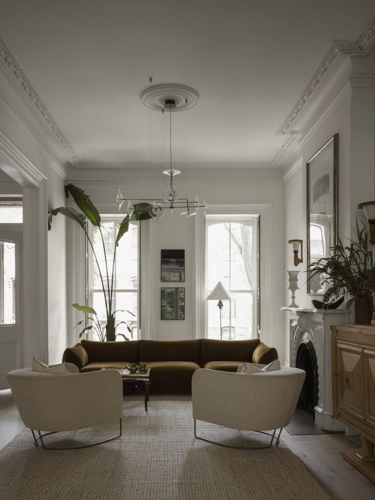 Wide-angle view of a Brooklyn brownstone parlor floor featuring wide-plank Madera oak floors and original crown molding.