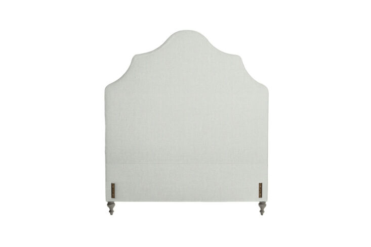 The Pondicherry Headboard featuring a tall, elegantly curved silhouette.