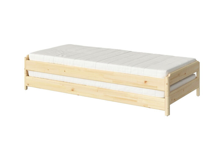 A pair of IKEA UTÅKER solid pine stackable bed frames styled in a neutral-toned room.