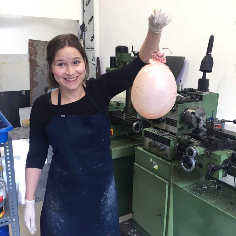 Juliane Fink in her studio holding the raw pig bladder material used for the bowls.