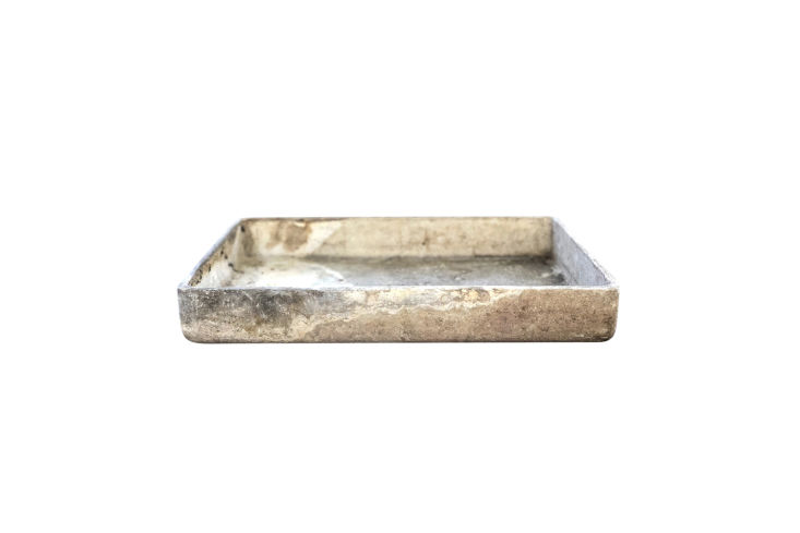 A cement rectangular planter that can be repurposed as a bathroom sink.