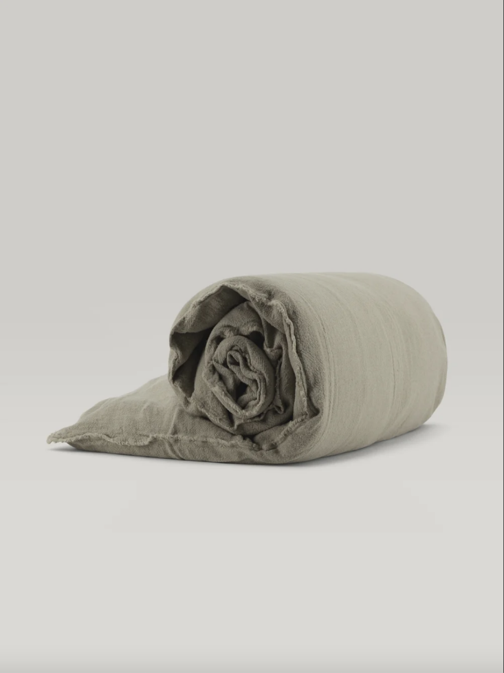 A neutral-toned linen sofa topper highlighting its naturally embossed texture.