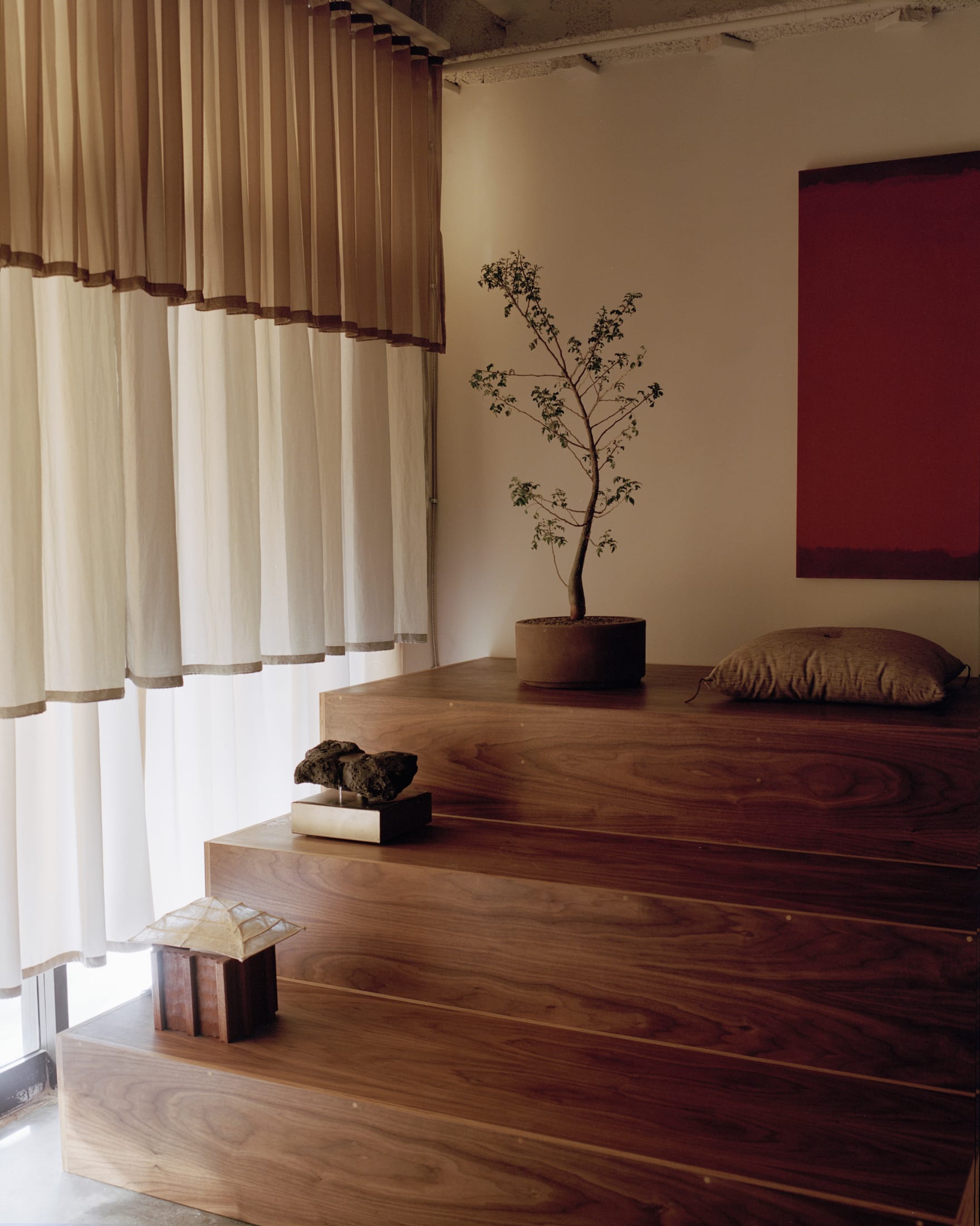 Close-up of rich walnut furniture and soft lighting creating a sensory-rich environment.