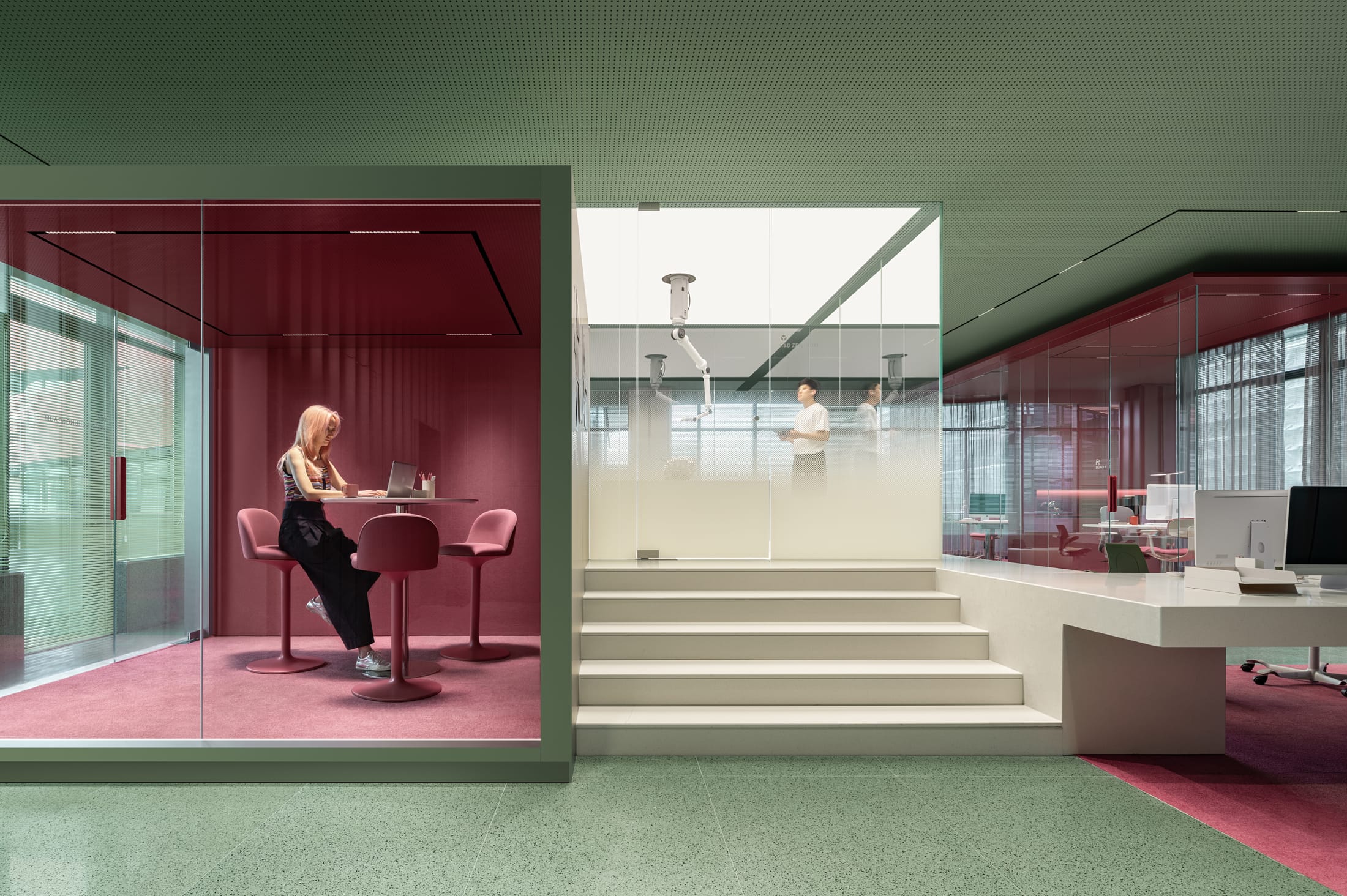 Detailed view of the suspended capsule's anodized aluminum exterior and the sea-green terrazzo elements.